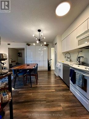 Toronto (Waterfront Communities) condo for rent - A kitchen with a table and chairs in the middle of the room.