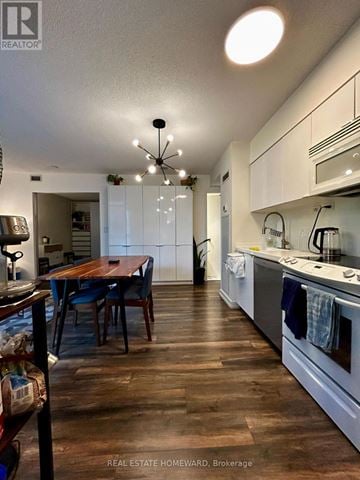 Toronto (Waterfront Communities) condo for rent - A kitchen with a table and chairs in the middle of the room.