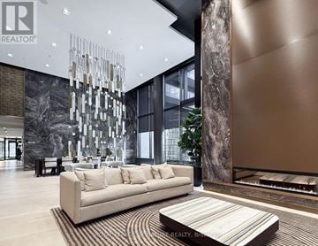Toronto (Mount Pleasant West) condo for rent - A modern living room with a large couch and a chandelier.