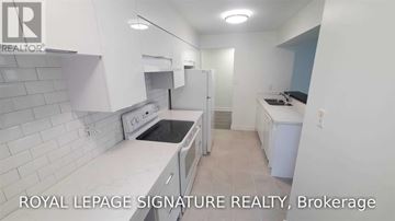 Toronto (Bay Street Corridor) condo for rent - A white kitchen with a refrigerator, oven, and sink.