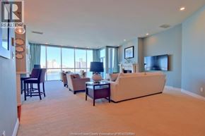 Windsor condo for rent - A living room with a couch, chairs, and a television.