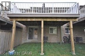 Kitchener townhouse for rent - A wooden deck over a house with a white railing.