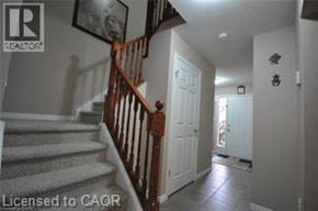 Kitchener townhouse for rent - A hallway with a staircase and a door.