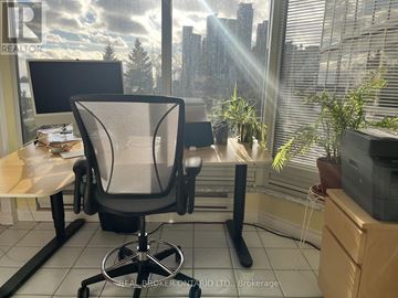Toronto (Mimico) condo for rent - A white kitchen with a black oven and a white tiled floor.