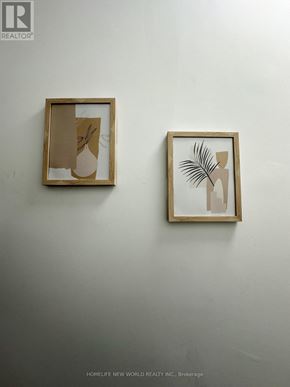 Cobourg condo for rent - Two framed pieces of artwork hang on a wall.
