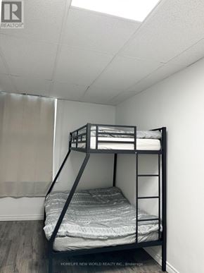Cobourg condo for rent - A bunk bed in a room with a HomeLife New World REALTY INC. brokerage logo.