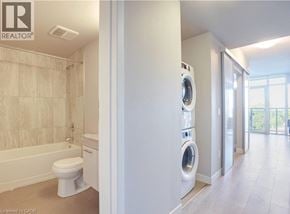 Waterloo condo for rent - A bathroom with a washer and dryer built into the wall.