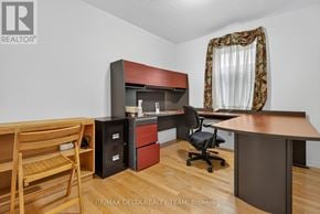 Ottawa apartment for rent - A room with a desk, chair, and a cabinet with a microwave and coffee maker.