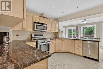 Ottawa apartment for rent - A kitchen with a granite counter top and wooden cabinets.