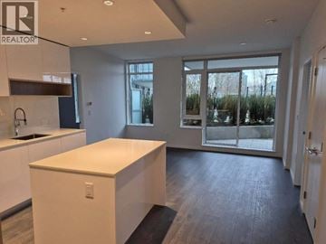 Richmond apartment for rent - A realtor sign is on the wall above a kitchen island.