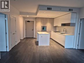 Richmond apartment for rent - A modern kitchen with a white island in the middle.