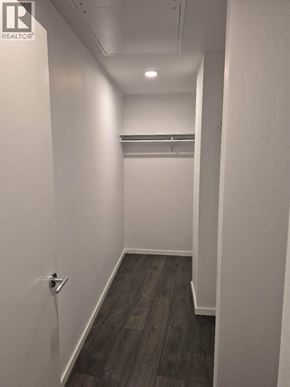Richmond apartment for rent - A hallway with a door on the left and a coat rack on the right.