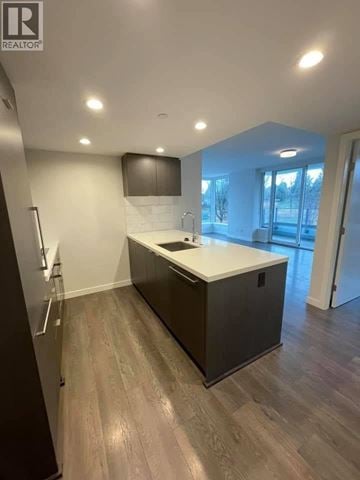 Vancouver apartment for rent - A kitchen with a wooden floor and a white counter.