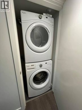 Vancouver apartment for rent - A white washing machine and dryer in a small laundry room.