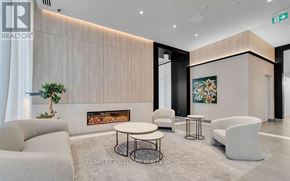 Hamilton (Beasley) condo for rent - A modern waiting area with a fireplace and comfortable seating.
