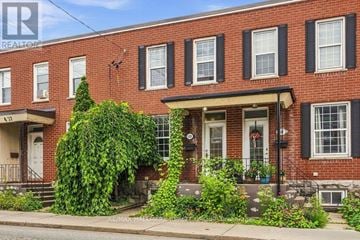 Ottawa townhouse for rent - A red brick house with a white door and windows.