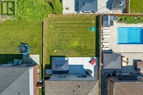 Pelham (Fonthill) apartment for rent - A bird's eye view of a backyard with a pool and a lawn.
