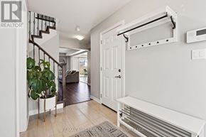 Pelham (Fonthill) apartment for rent - A white hallway with a staircase and a bench.