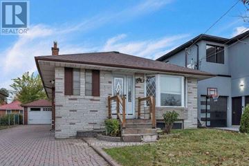 Toronto (Wexford-Maryvale) apartment for rent - A house with a brown roof and a white garage door.