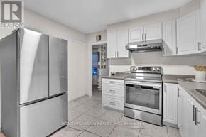 Toronto (Wexford-Maryvale) apartment for rent - A kitchen with a refrigerator, oven, and cabinets.
