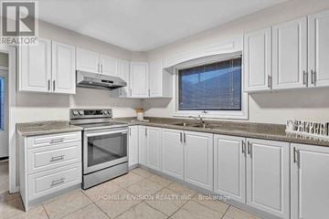 Toronto (Wexford-Maryvale) apartment for rent - A kitchen with white cabinets and a stainless steel oven.