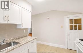 Windsor apartment for rent - A kitchen with white cabinets and a granite countertop.