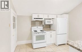Windsor apartment for rent - A kitchen with white appliances and cabinets.
