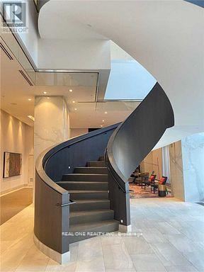 Toronto (Islington-City Centre West) condo for rent - A staircase in a building with a sign that says "REAL ONE REALTY".