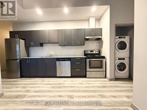 Waterloo condo for rent - A kitchen with a refrigerator, oven, and washing machine.
