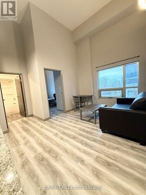 Waterloo condo for rent - A spacious living room with a couch, a coffee table, and a large window.