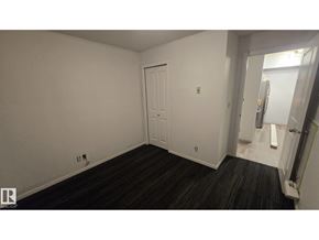 Edmonton apartment for rent - A room with a white door and a black floor.