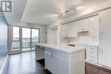 Toronto (Waterfront Communities) condo for rent - A kitchen with white cabinets and a large island.