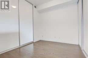 Toronto (Waterfront Communities) condo for rent - A room with a white wall and a wooden floor.