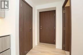 Toronto (Waterfront Communities) condo for rent - A hallway with two doors and a brokerage sign.