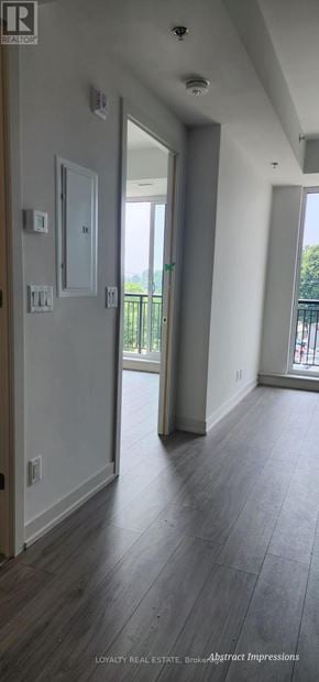 Toronto (Birchcliffe-Cliffside) condo for rent - A hallway with wood floors and white walls.