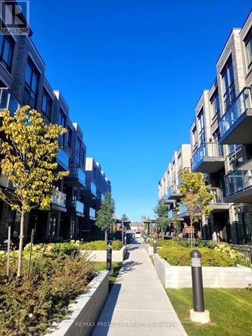 Brampton (Bram East) condo for rent - A sunny day in a modern residential area with a clear blue sky.