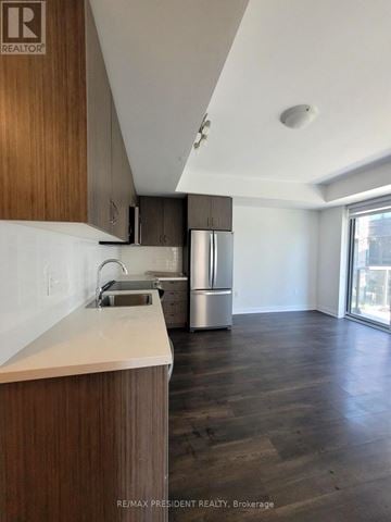 Brampton (Bram East) condo for rent - A kitchen with wooden cabinets and a stainless steel refrigerator.