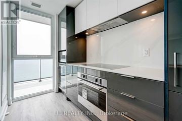 Toronto (Mimico) condo for rent - A modern kitchen with a stainless steel oven and white cabinets.
