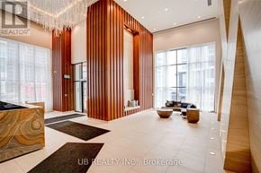 Toronto (Mimico) condo for rent - A modern interior space with wooden walls and a reception desk.
