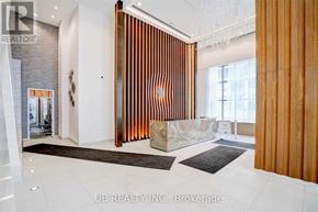 Toronto (Mimico) condo for rent - A modern interior space with a wooden partition and a white floor.