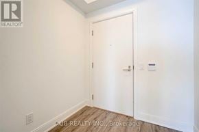 Toronto (Mimico) condo for rent - A white door in a room with a brokerage sign on the wall.