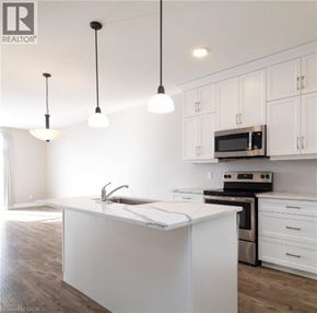 North Perth townhouse for rent - A kitchen with white cabinets and a white island.