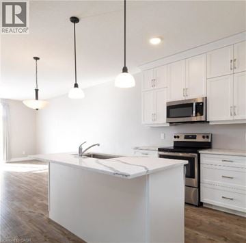 North Perth townhouse for rent - A kitchen with white cabinets and a white island.