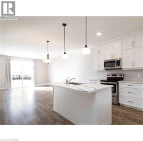 North Perth townhouse for rent - A modern kitchen with white cabinets and a large island.
