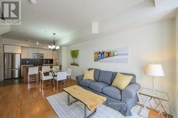 Toronto (Islington-City Centre West) townhouse for rent - A living room with a grey couch and a painting on the wall.