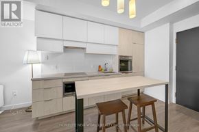 Toronto (Mount Pleasant West) condo for rent - A modern kitchen with a white and wood color scheme.