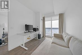 Toronto (Mount Pleasant West) condo for rent - A white room with a desk and a couch.