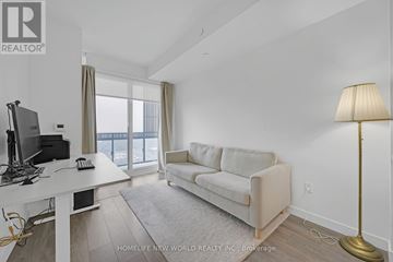 Toronto (Mount Pleasant West) condo for rent - A well-lit, modern living room with a white sofa and a desk with a computer.