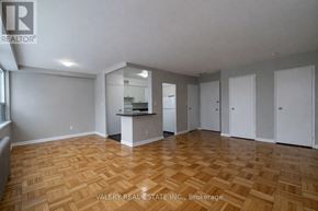 Toronto (Thorncliffe Park) condo for rent - A spacious room with wooden flooring and white walls.