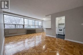 Toronto (Thorncliffe Park) condo for rent - A spacious room with wooden flooring and large windows.